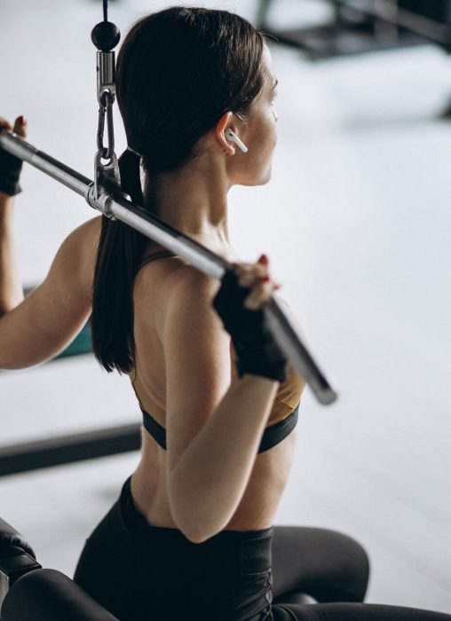young-attractive-woman-exercising-gym